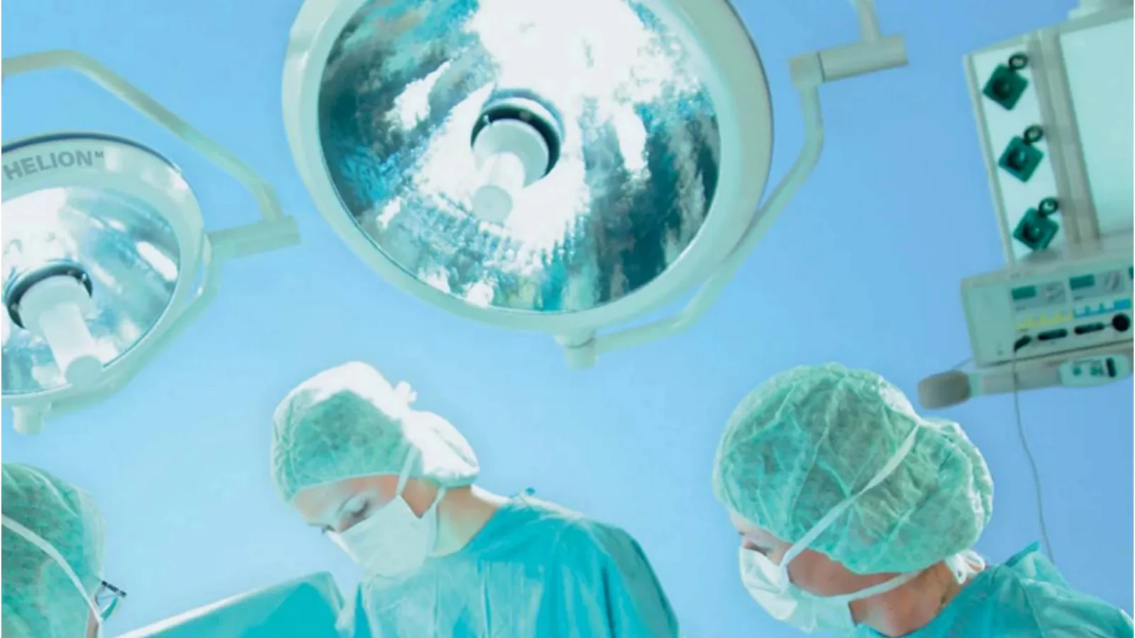 Surgeons work beneath a Trumpf Helion halogen light.